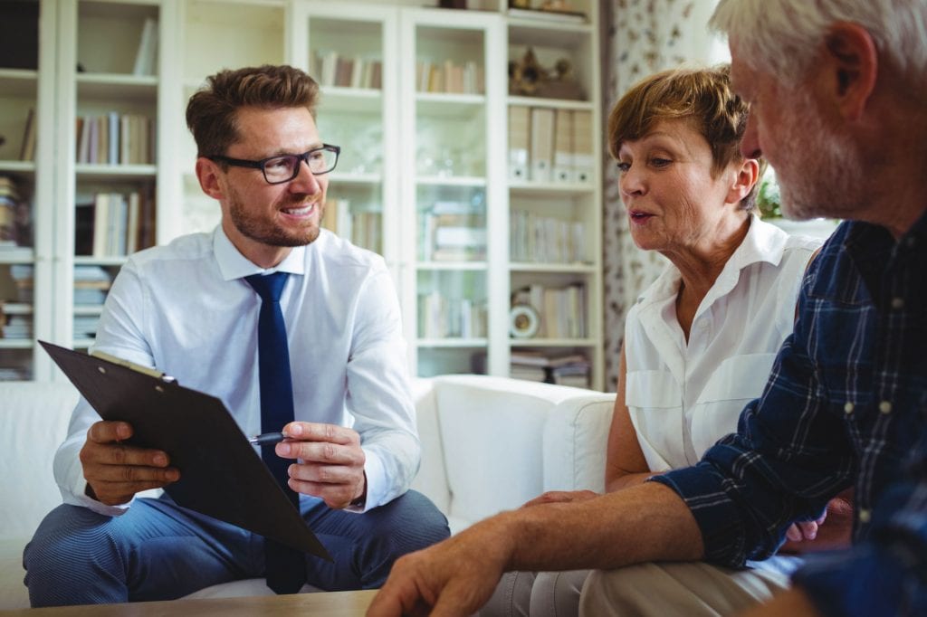 Senior couple planning their investments with long-term care advisor